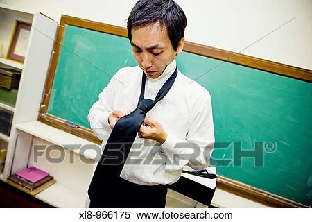 Groom, man putting on tie View Large Photo Image Stock Photography - Groom, man putting on tie. Fotosearch