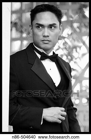 Stock Image - Groom posing outside. Fotosearch