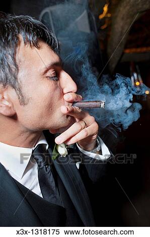 Stock Photography - groom smoking a cigar. Fotosearch