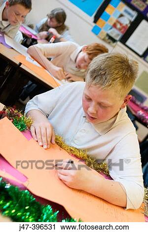 Group of 12 year old children, sitting in class, concentrating, drawing View Large Photo Image Stock Image - Group of 12 year old children, sitting in class, concentrating, drawing. Fotosearch