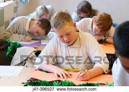 Group of 12 year old children, sitting in class, concentrating, drawing View Large Photo Image Stock Photo - Group of 12 year old children, sitting in class, concentrating, drawing. Fotosearch