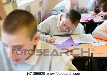 Group of 12 year old children, sitting in class, concentrating, drawing View Large Photo Image Stock Photo - Group of 12 year old children, sitting in class, concentrating, drawing. Fotosearch