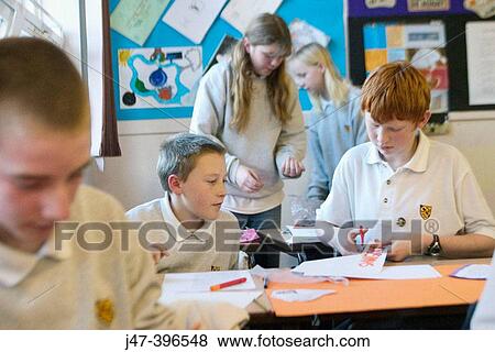 Group of 12 year old children, sitting in class, concentrating, drawing View Large Photo Image Stock Photo - Group of 12 year old children, sitting in class, concentrating, drawing. Fotosearch