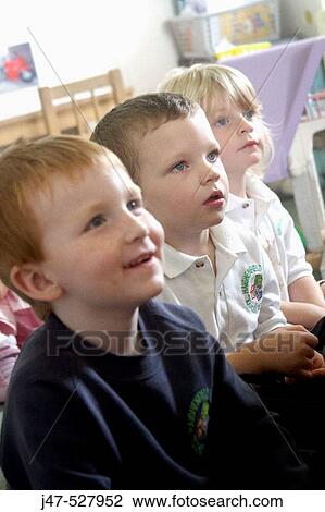Group of 2-4 year old children sitting in the classroom in a row View Large Photo Image Stock Image - Group of 2-4 year old children sitting in the classroom in a row. Fotosearch