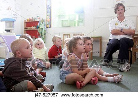 Group of 2-4 year old children sitting in the classroom with the teacher View Large Photo Image Stock Photo - Group of 2-4 year old children sitting in the classroom with the teacher. Fotosearch