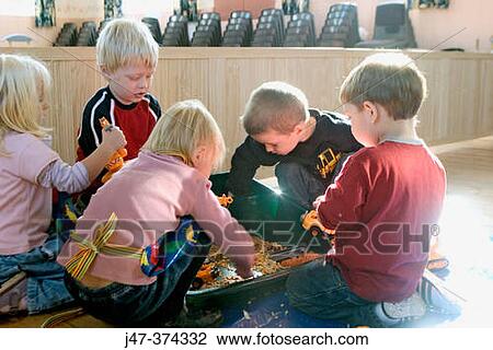 Group of 3 - 4 year old children playing at nursrey school, with toy tractors View Large Photo Image Stock Image - Group of 3 - 4 year old children playing at nursrey school, with toy tractors. Fotosearch