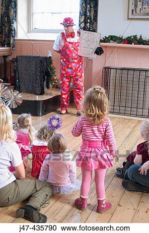 Group of 3 year old children at a party, with a clown View Large Photo Image Stock Image - Group of 3 year old children at a party, with a clown. Fotosearch