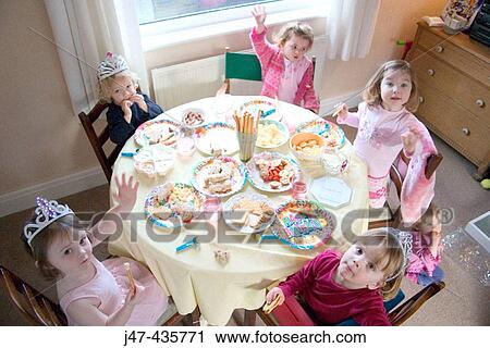 Group of 3 year old girls sitting round a table having a party View Large Photo Image Stock Image - Group of 3 year old girls sitting round a table having a party. Fotosearch
