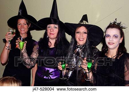 Group of 30 year old women dressed up in Halloween fancy dress, smiling and holding their glasses up to the camera View Large Photo Image Picture - Group of 30 year old women dressed up in Halloween fancy dress, smiling and holding their glasses up to the camera. Fotosearch