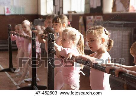 Group of 6 year old girls in ballet class, dressed in pink leotards at a ballet bar. View Large Photo Image Stock Image - Group of 6 year old girls in ballet class, dressed in pink leotards at a ballet bar.. Fotosearch