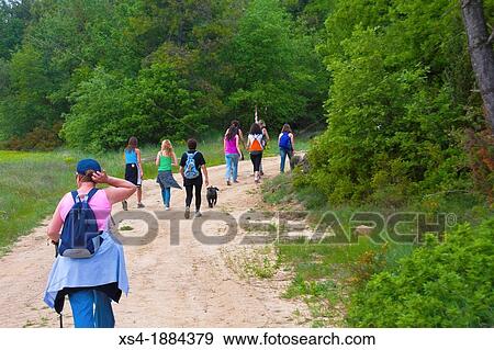 Group of 9 women hiking through the countryside in spring time with backpack and a dog Photo taken in Pinos, Lleida, Spain, Europe View Large Photo Image Stock Photo - Group of 9 women hiking through the countryside in spring time with backpack and a dog Photo taken in Pinos, Lleida, Spain, Europe. Fotosearch