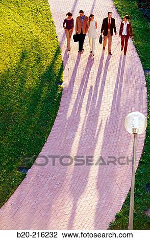 Group of businesspeople walking View Large Photo Image Stock Image - Group of businesspeople walking. Fotosearch