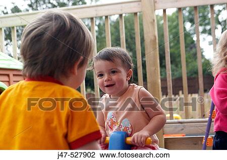 Group of children at nursery playing outside View Large Photo Image Stock Image - Group of children at nursery playing outside. Fotosearch
