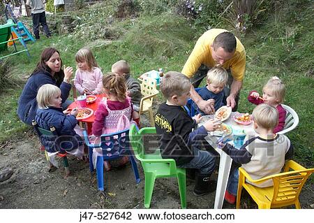 Group of children having a picnic in the garden View Large Photo Image Stock Image - Group of children having a picnic in the garden. Fotosearch