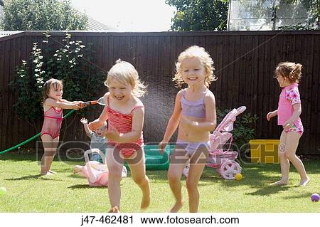 Group of children playing outside with a hose pipe View Large Photo Image Stock Image - Group of children playing outside with a hose pipe. Fotosearch