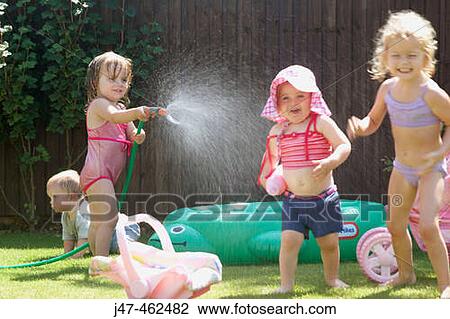 group of children playing outside with a hose pipe View Large Photo Image Stock Image - group of children playing outside with a hose pipe. Fotosearch