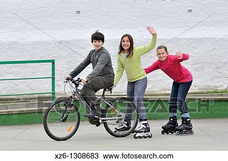 Group of children with bicycle and in-line skates. View Large Photo Image Stock Image - Group of children with bicycle and in-line skates.. Fotosearch