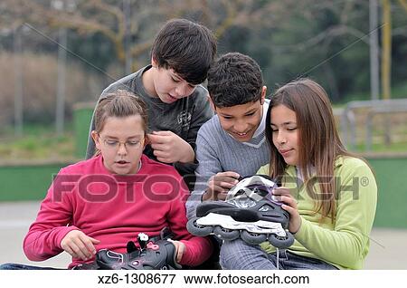 Stock Photo - Group of children with skates. Spain.. Fotosearch