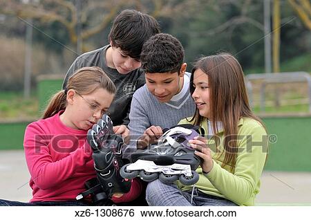Stock Photograph - Group of children with skates. Spain.. Fotosearch