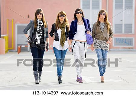 Stock Photo - Group of fancy teenage girls with eyeglasses are walking. Fotosearch