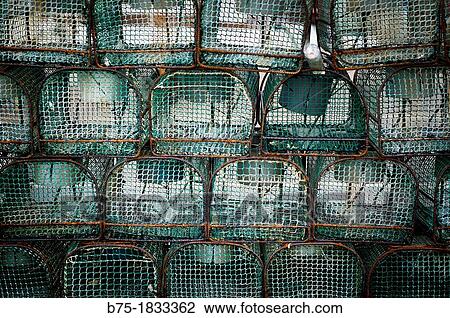 Stock Image - Group of fishing pots stacked in a fishing area of Luarca, Asturias, Northern Spain, Spain,. Fotosearch