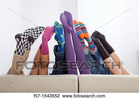Group of friends legs sticking up over a sofa View Large Photo Image Stock Image - Group of friends legs sticking up over a sofa. Fotosearch