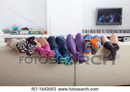 Group of friends legs sticking up over a sofa View Large Photo Image Stock Image - Group of friends legs sticking up over a sofa. Fotosearch