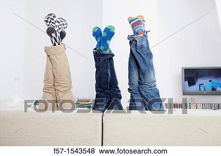 Group of friends legs sticking up over a sofa View Large Photo Image Stock Photo - Group of friends legs sticking up over a sofa. Fotosearch