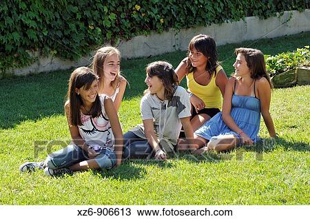 group of friends sitting on the floor of the park explaining jokes View Large Photo Image Stock Image - group of friends sitting on the floor of the park explaining jokes. Fotosearch