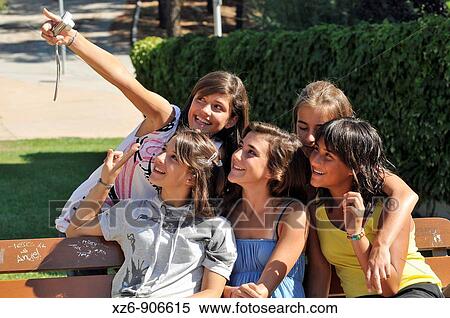group of girls taking a picture of themselves in the park View Large Photo Image Stock Photography - group of girls taking a picture of themselves in the park. Fotosearch