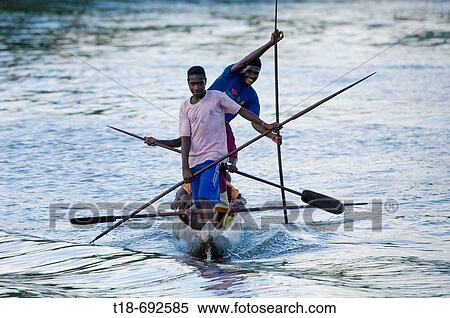 Group of men paddling dug out, Indonesia View Large Photo Image Stock Photography - Group of men paddling dug out, Indonesia. Fotosearch