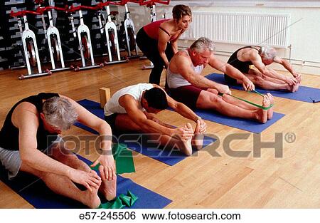 group of men practicing yoga in contemporary gym or office setting View Large Photo Image Stock Photograph - group of men practicing yoga in contemporary gym or office setting. Fotosearch
