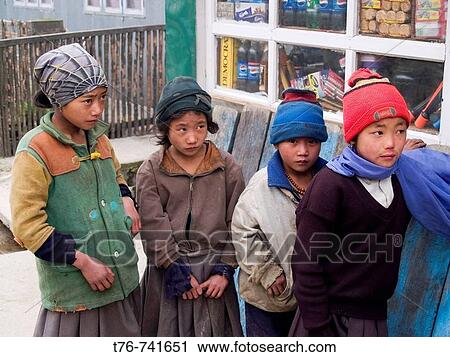 Stock Image - group of Nepali children bundled up in a village on the Singalila Ridge trek along the Nepal India border. Fotosearch