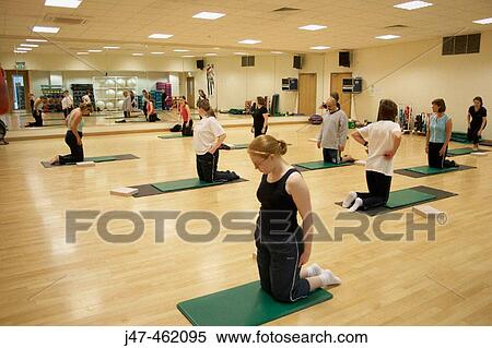 Group of people in a pilates class, kneeling up View Large Photo Image Stock Photography - Group of people in a pilates class, kneeling up. Fotosearch