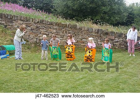 Group of pre school children doing a sack race on sports day View Large Photo Image Stock Image - Group of pre school children doing a sack race on sports day. Fotosearch