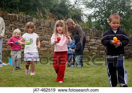 Group of pre school children doing an egg and spoon race on sports day View Large Photo Image Stock Photo - Group of pre school children doing an egg and spoon race on sports day. Fotosearch