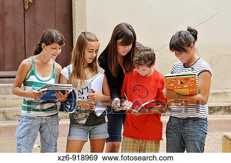 Stock Photo - group of students taking a lesson outside the historic building. Fotosearch
