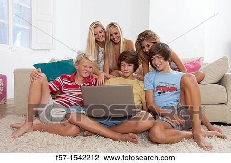 Group of teenagers communicating with a laptop View Large Photo Image Stock Image - Group of teenagers communicating with a laptop. Fotosearch