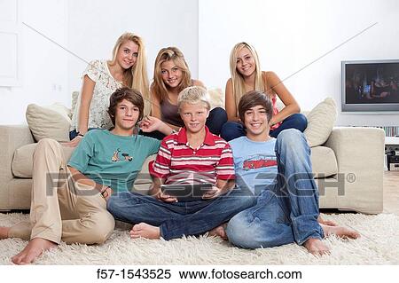 Group of teenagers communicating with a digital tablet View Large Photo Image Stock Photography - Group of teenagers communicating with a digital tablet. Fotosearch