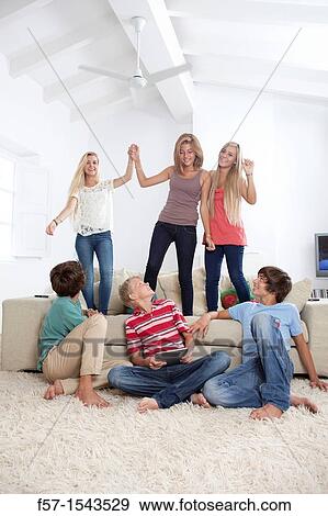 Stock Photo - Group of teenagers dancing to music on a tablet. Fotosearch