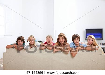 Group of teenagers on a sofa looking to camera View Large Photo Image Stock Image - Group of teenagers on a sofa looking to camera. Fotosearch