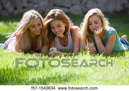 Group of Teenagers on their Blackberry? s View Large Photo Image Picture - Group of Teenagers on their Blackberry? s. Fotosearch