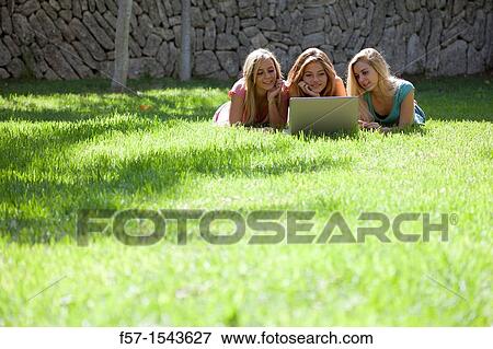 Group of Teenagers with laptop in the garden View Large Photo Image Stock Photo - Group of Teenagers with laptop in the garden. Fotosearch