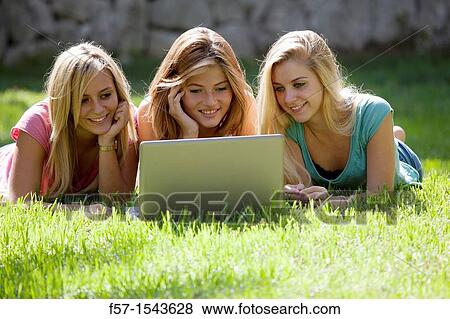 Group of Teenagers with laptop in the garden View Large Photo Image Stock Photo - Group of Teenagers with laptop in the garden. Fotosearch