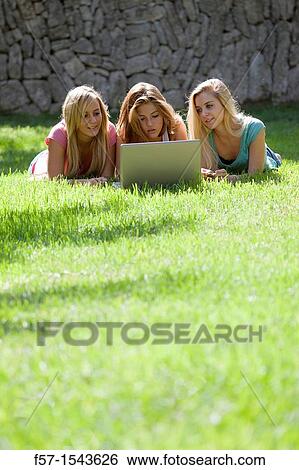 Group of Teenagers with laptop in the garden View Large Photo Image Stock Photograph - Group of Teenagers with laptop in the garden. Fotosearch