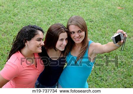 Group of teens taking a picture or themselves View Large Photo Image Picture - Group of teens taking a picture or themselves. Fotosearch