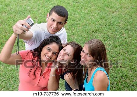 Group of teens taking a picture or themselves View Large Photo Image Stock Photograph - Group of teens taking a picture or themselves. Fotosearch