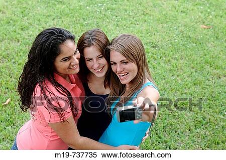 Stock Photography - Group of teens taking a picture or themselves. Fotosearch