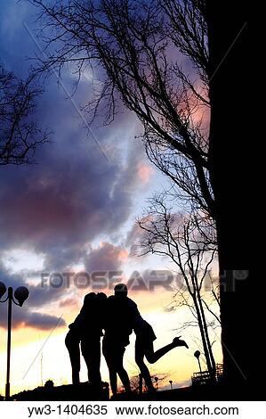Group of the people on an evening background View Large Photo Image Stock Photography - Group of the people on an evening background. Fotosearch