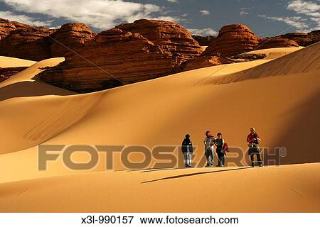 Group of tourists and tuareg in Oued Tin Tarabine Tassili Ahaggar Sahara desert Algeria View Large Photo Image Stock Photo - Group of tourists and tuareg in Oued Tin Tarabine Tassili Ahaggar Sahara desert Algeria. Fotosearch